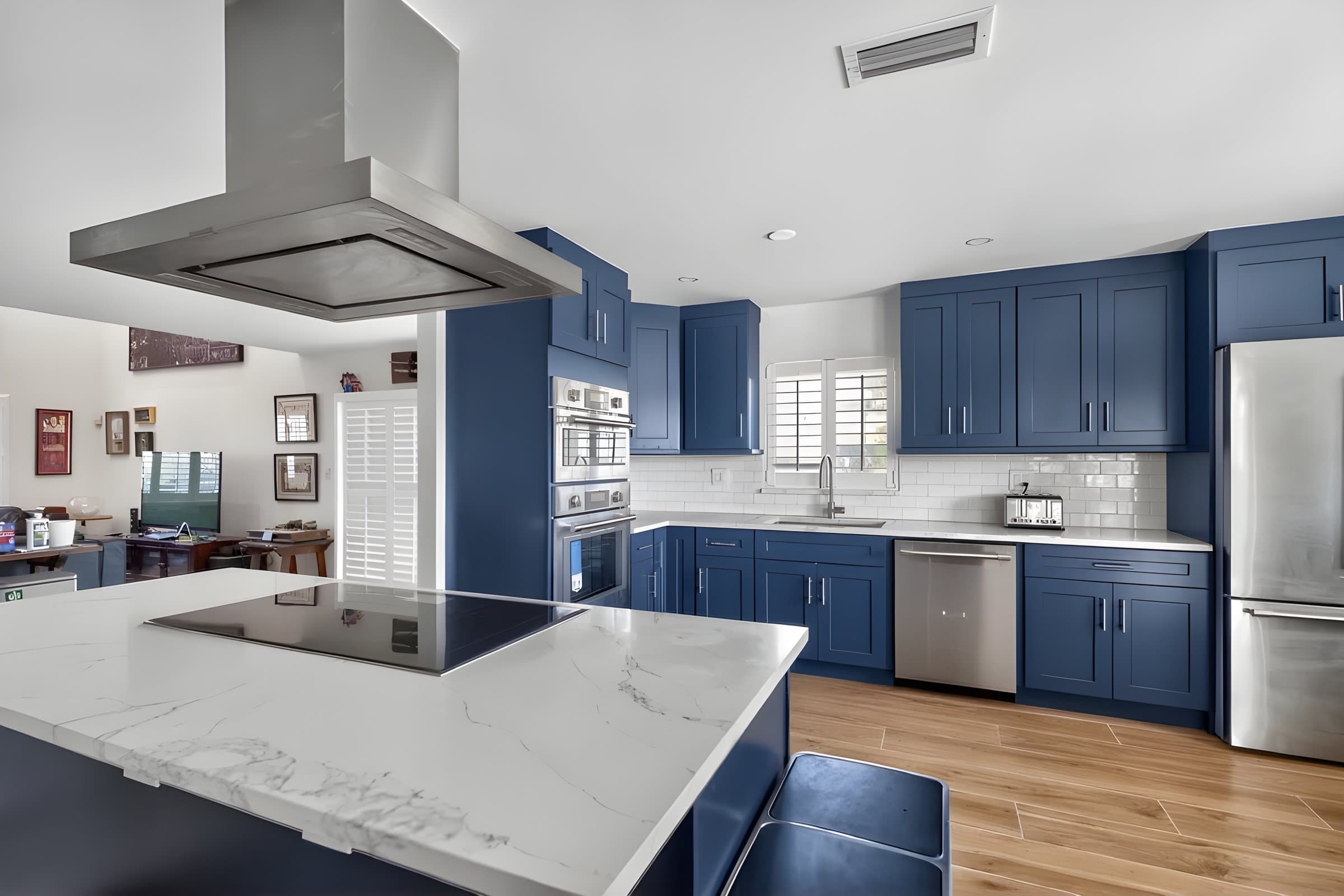 Blue shaker kitchen cabinets with marble island, installed by Every10Supply